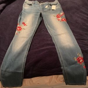 Express jeans with red and white embroidery flowers. Still with tags on.